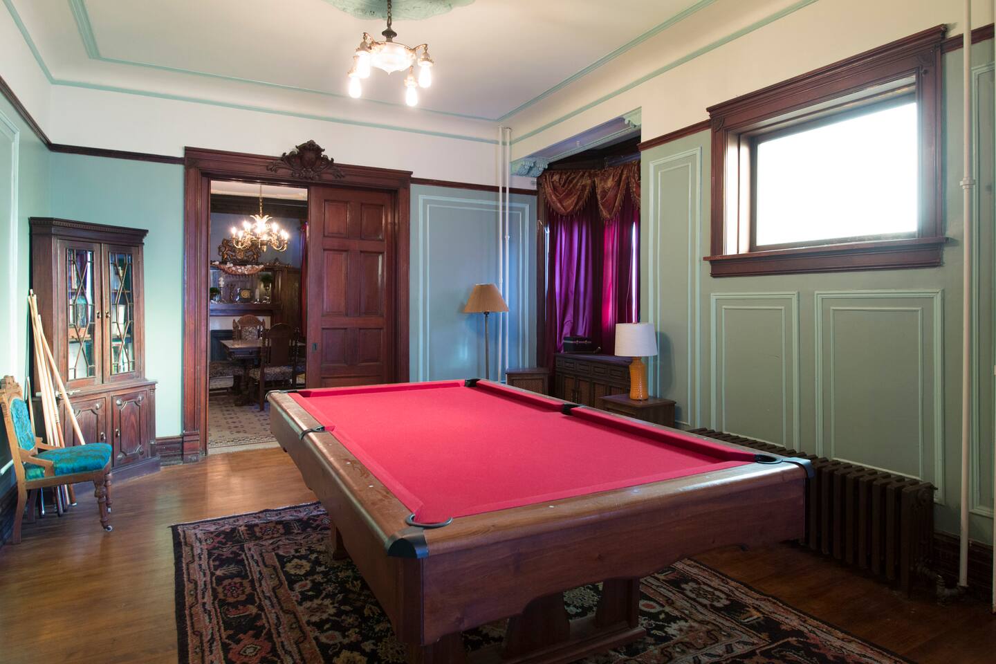 Billiards room with red pool table and wood paneling