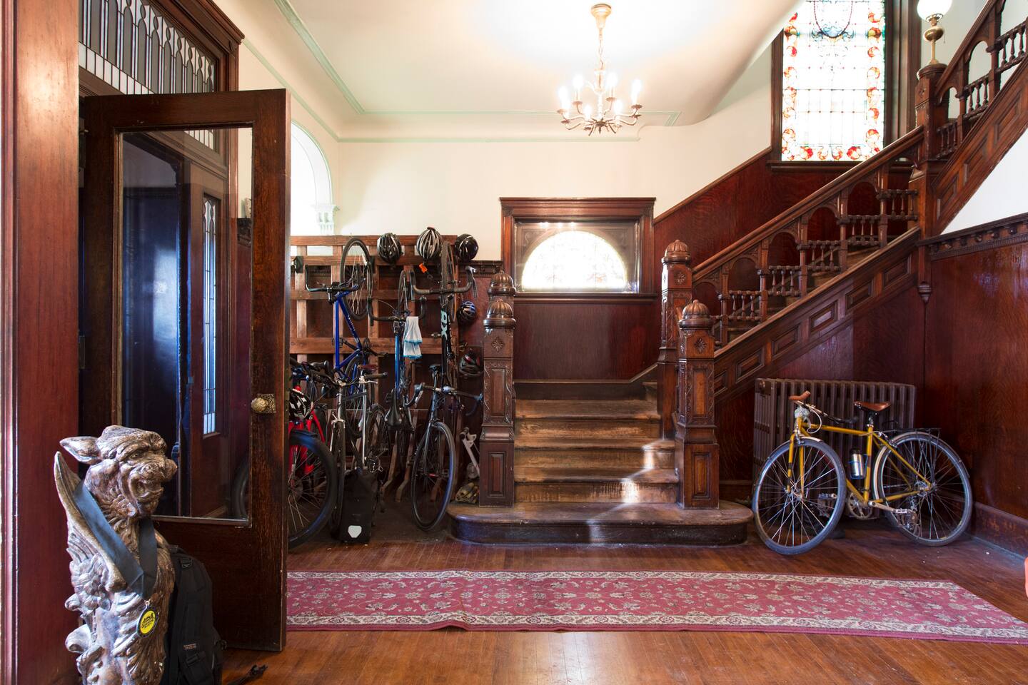 Entrance hall with an ornate wooden staircase and front door